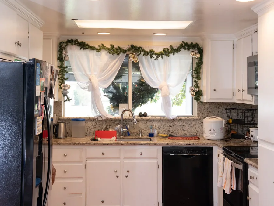 Bright kitchen with granite countertops and white cabinets